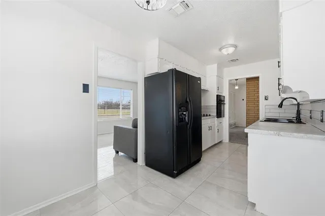 a kitchen with a refrigerator and a sink