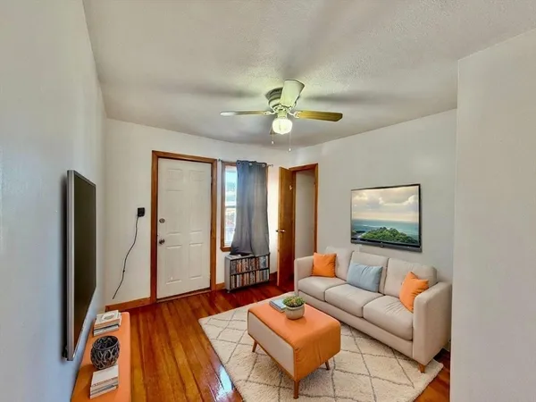 a living room with furniture a large window and a flat screen tv
