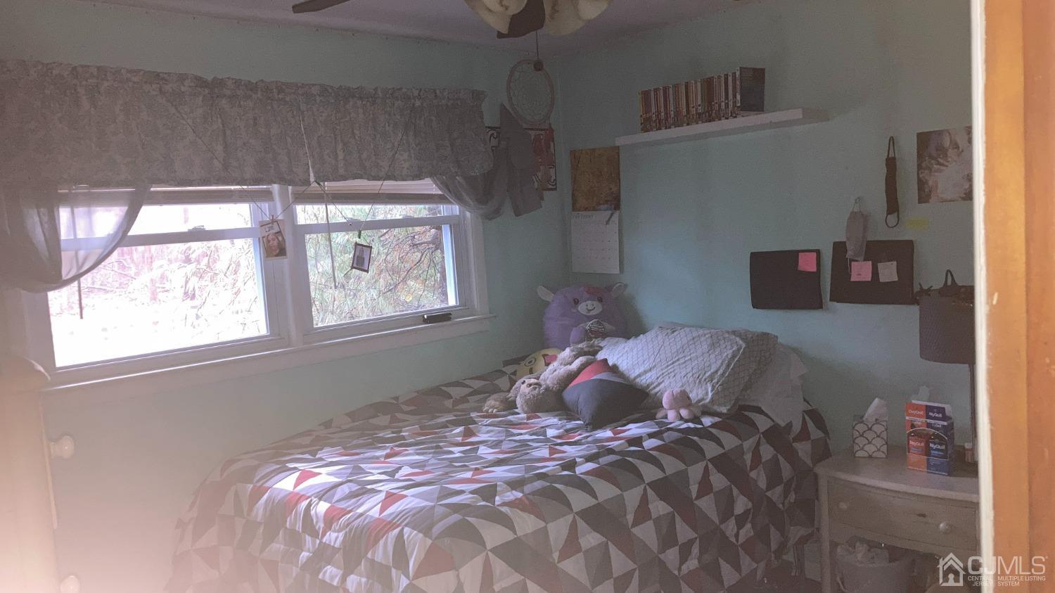 133 East Greystone Road Old Bridge, NJ 08857 - Photo 10 of 23 a bed sitting in a bedroom next to a window