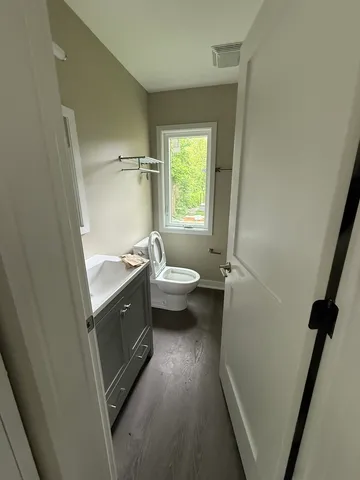 a kitchen with white cabinets and sink