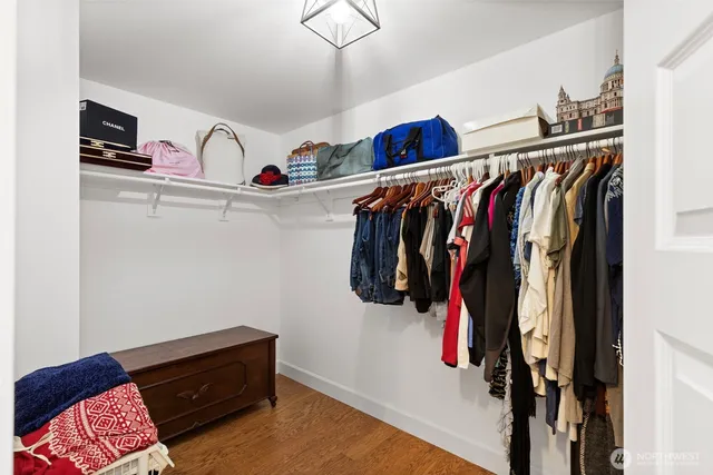 a view of walk in closet with clothes and shoes