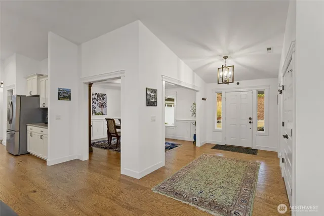 a view of a big room with windows and chandelier