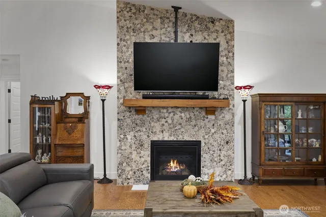 a living room with furniture a flat screen tv and a fireplace