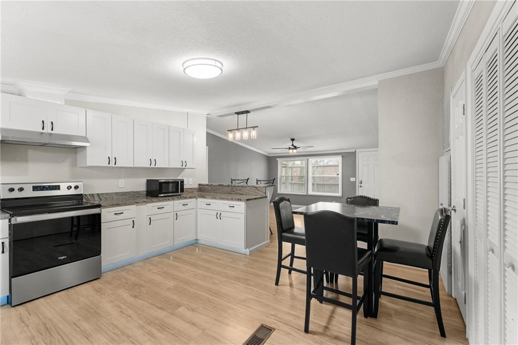 2038 Upper Salem Church Road Jasper, GA 30143 - Photo 12 of 25 a kitchen with a table chairs a sink and cabinets
