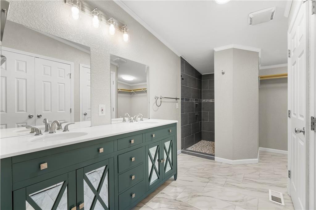 2038 Upper Salem Church Road Jasper, GA 30143 - Photo 14 of 25 a spacious bathroom with a double vanity sink a mirror and a shower