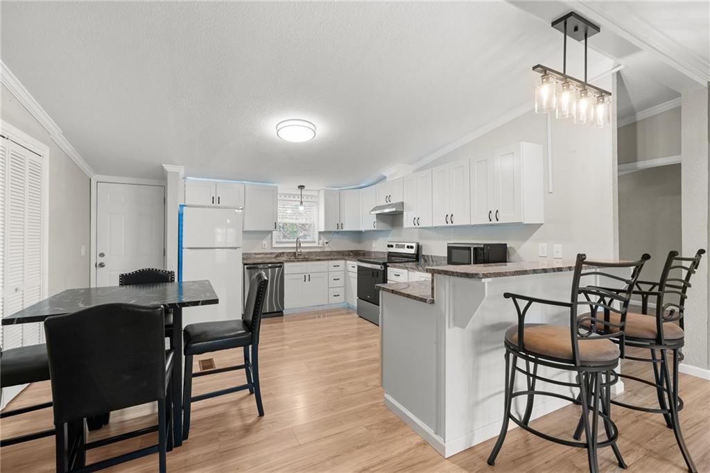 2038 Upper Salem Church Road Jasper, GA 30143 - Photo 10 of 25 a kitchen with stainless steel appliances kitchen island granite countertop a table chairs and a refrigerator