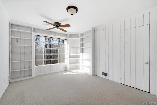 an empty room with a empty space and windows