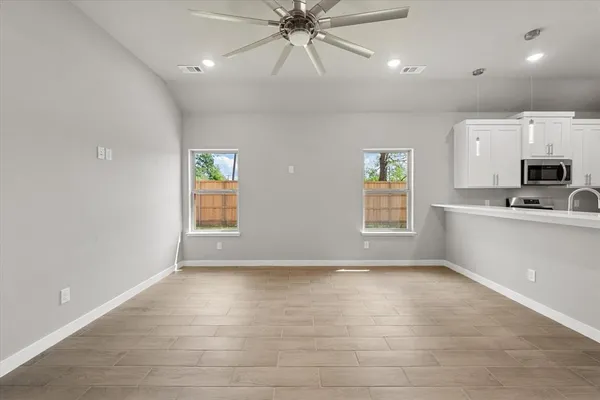 a view of a kitchen with a sink and a window