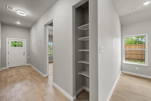 an empty room with windows and closet