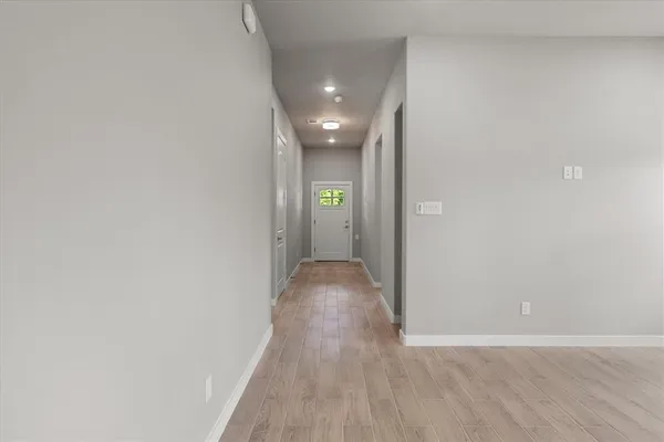 a view of hallway with wooden floor