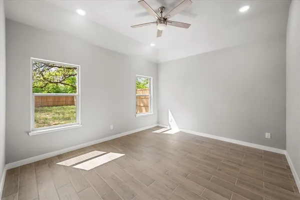 an empty room with windows and closet