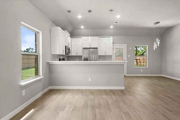 a view of kitchen with wooden floor and window
