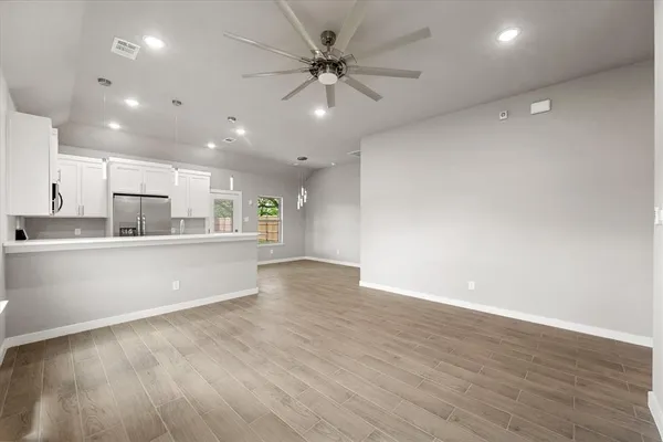 a view of kitchen with wooden floor and window