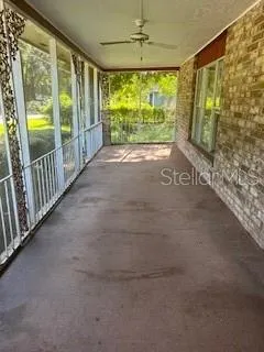 a view of a porch with wooden floor and door