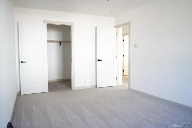 an empty room with closet and a bathroom
