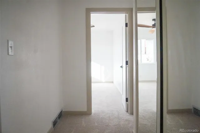 a view of a bathroom from a hallway