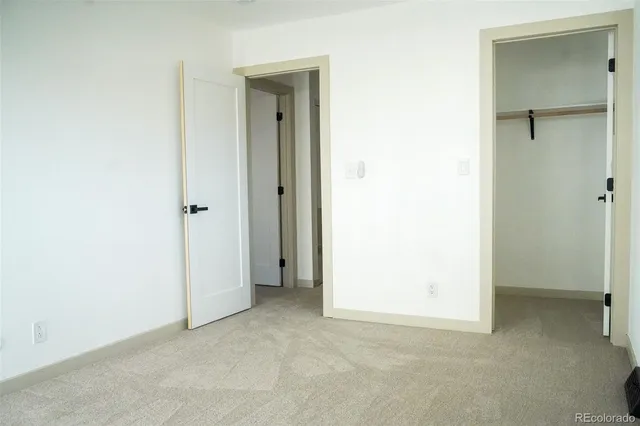 a view of an empty room and closet area