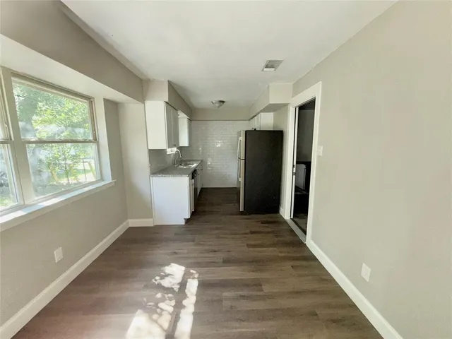 a view of a kitchen with a sink and a window