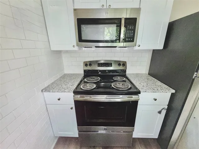a stove top oven sitting inside of a kitchen