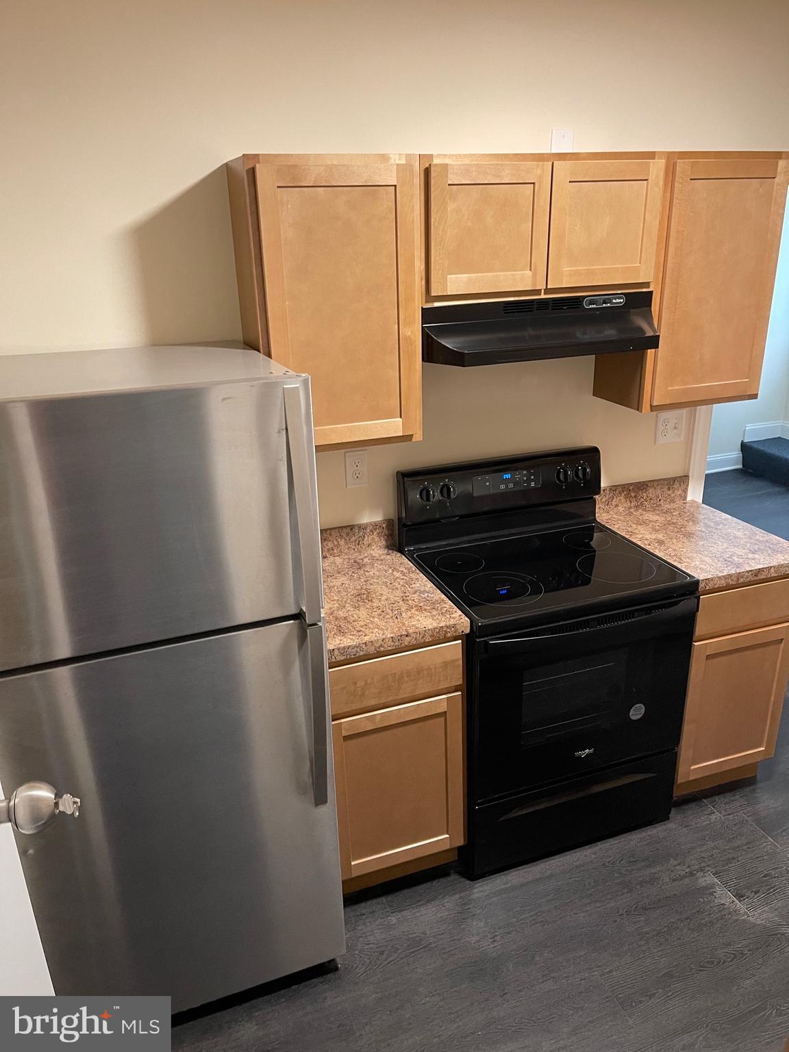 a kitchen with a refrigerator and a stove