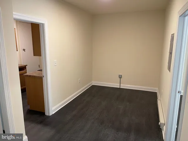 an empty room with wooden floor and a window