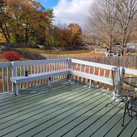 a view of a house with wooden deck
