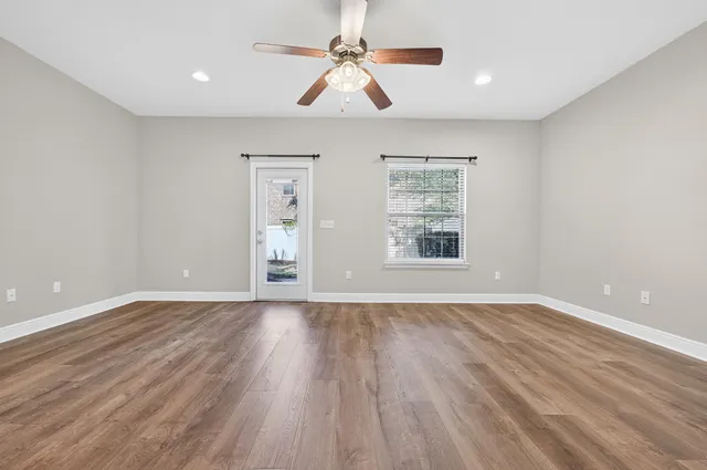 wooden floor in an empty room with a window