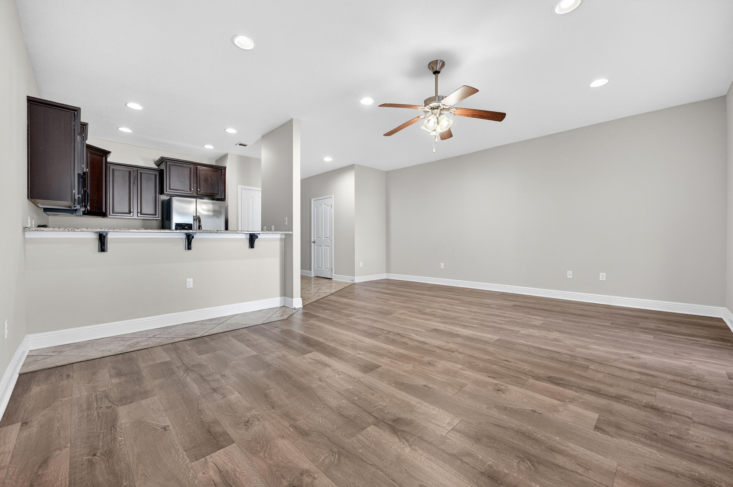 8900 White Ibis Way Navarre, FL 32566 - Photo 12 of 37 a view of kitchen with wooden floor and window