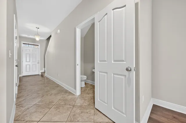 a white toilet sitting next to a shower