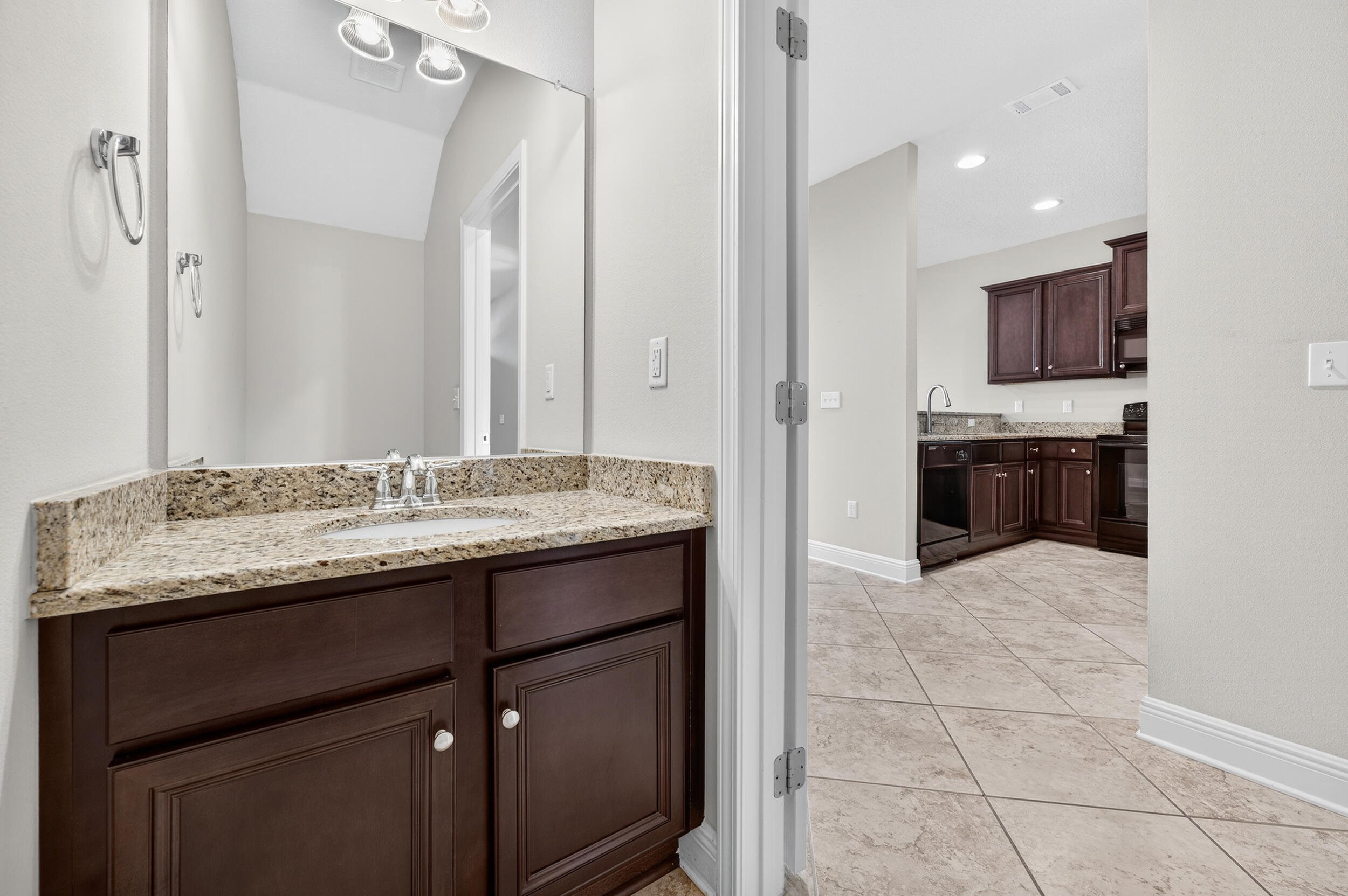 8900 White Ibis Way Navarre, FL 32566 - Photo 17 of 37 a bathroom with a granite countertop sink and a mirror
