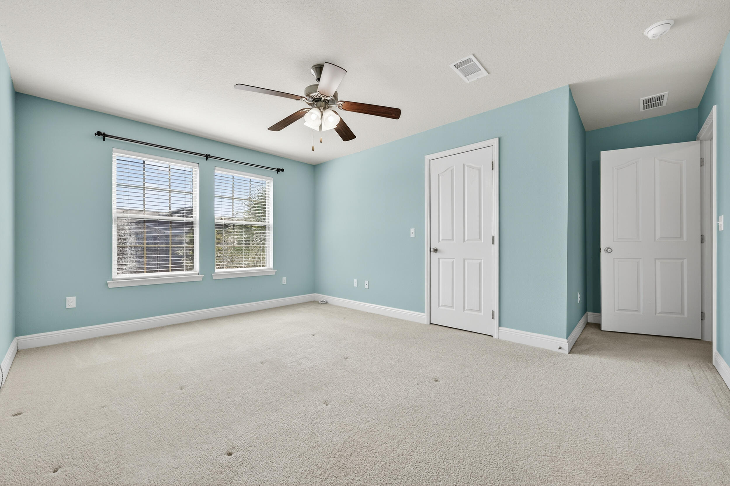 8900 White Ibis Way Navarre, FL 32566 - Photo 21 of 37 an empty room with windows and fan