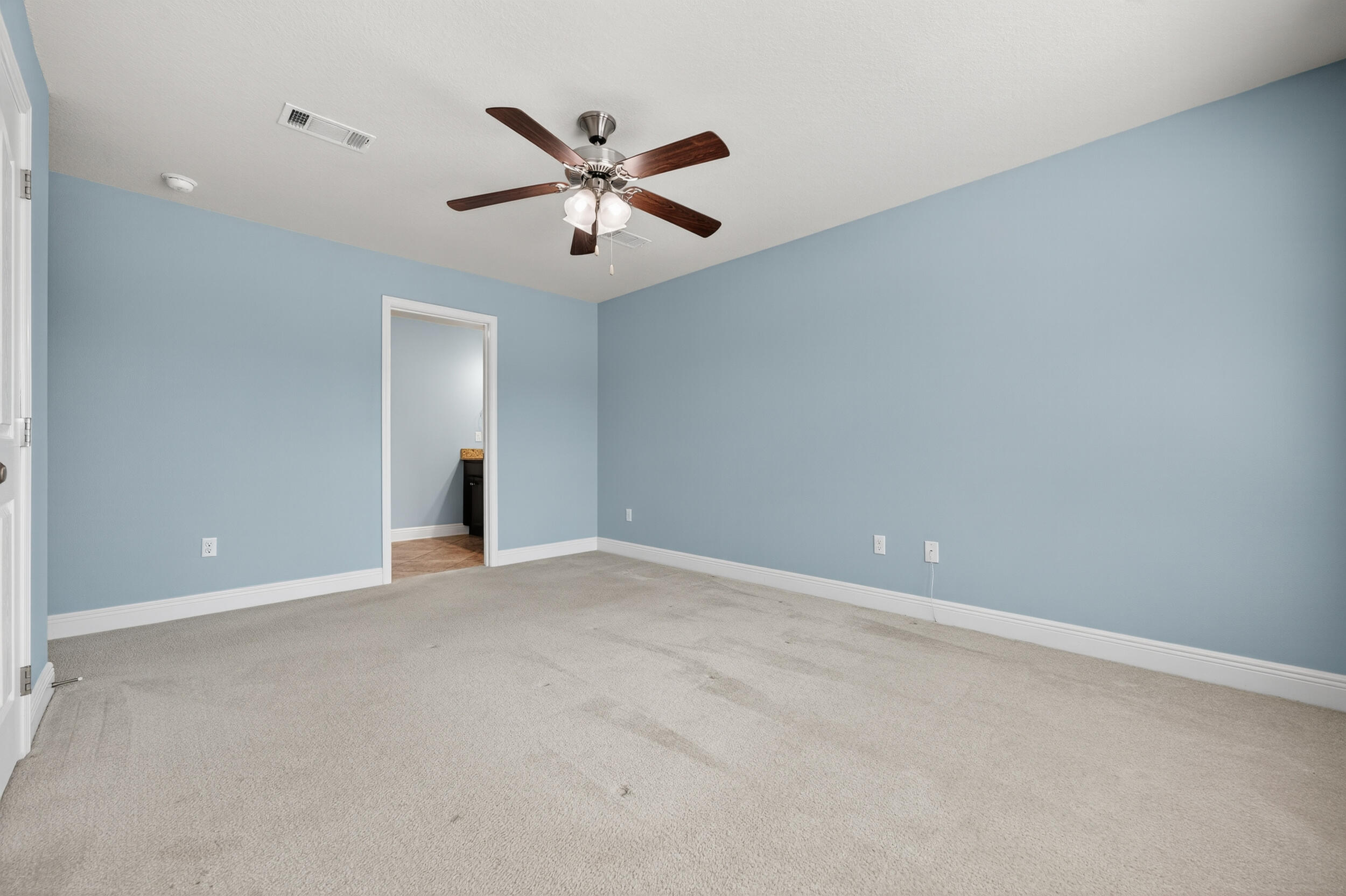 8900 White Ibis Way Navarre, FL 32566 - Photo 22 of 37 a view of an empty room with a ceiling fan
