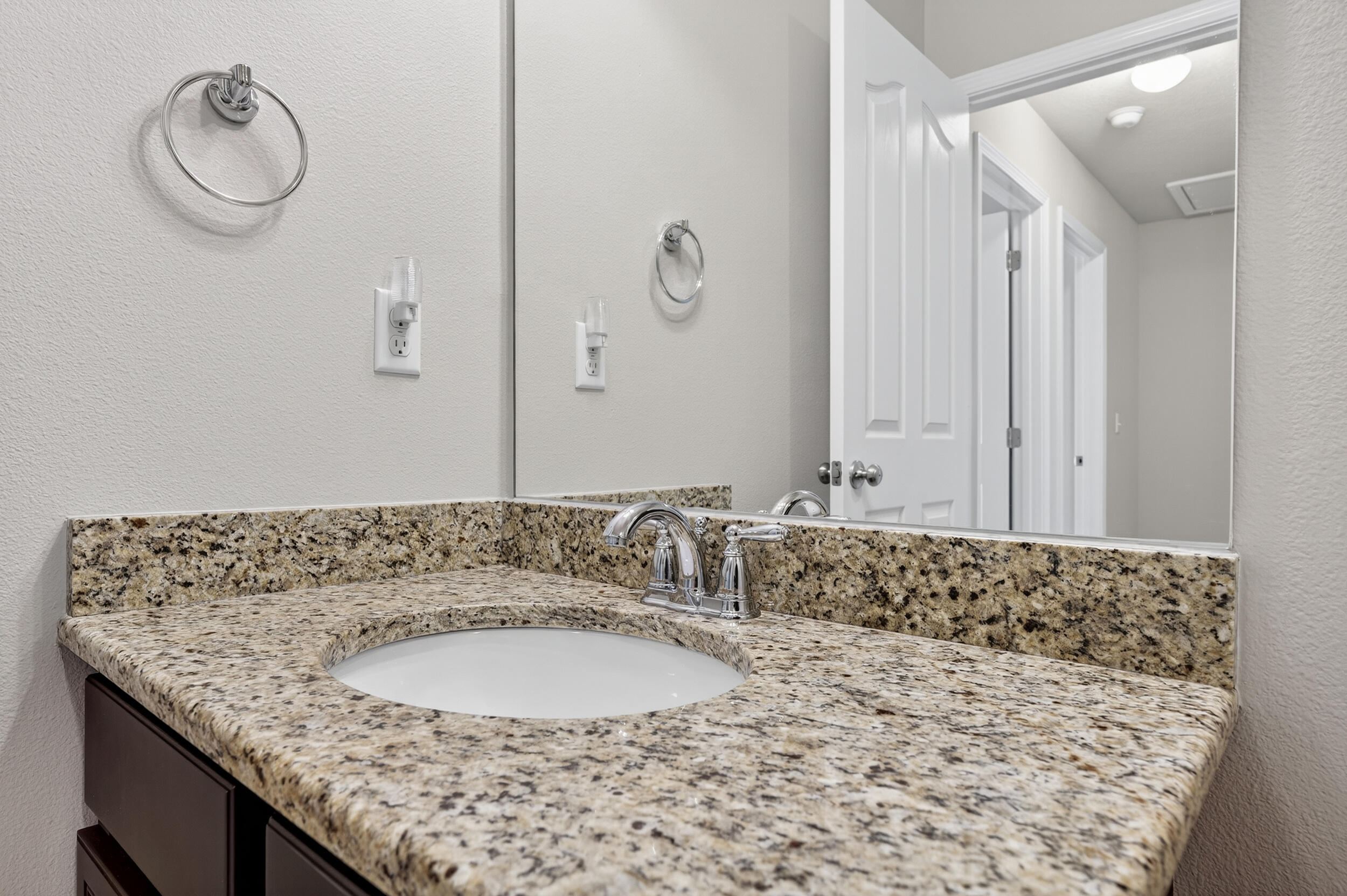 8900 White Ibis Way Navarre, FL 32566 - Photo 33 of 37 a bathroom with a granite countertop sink and a mirror