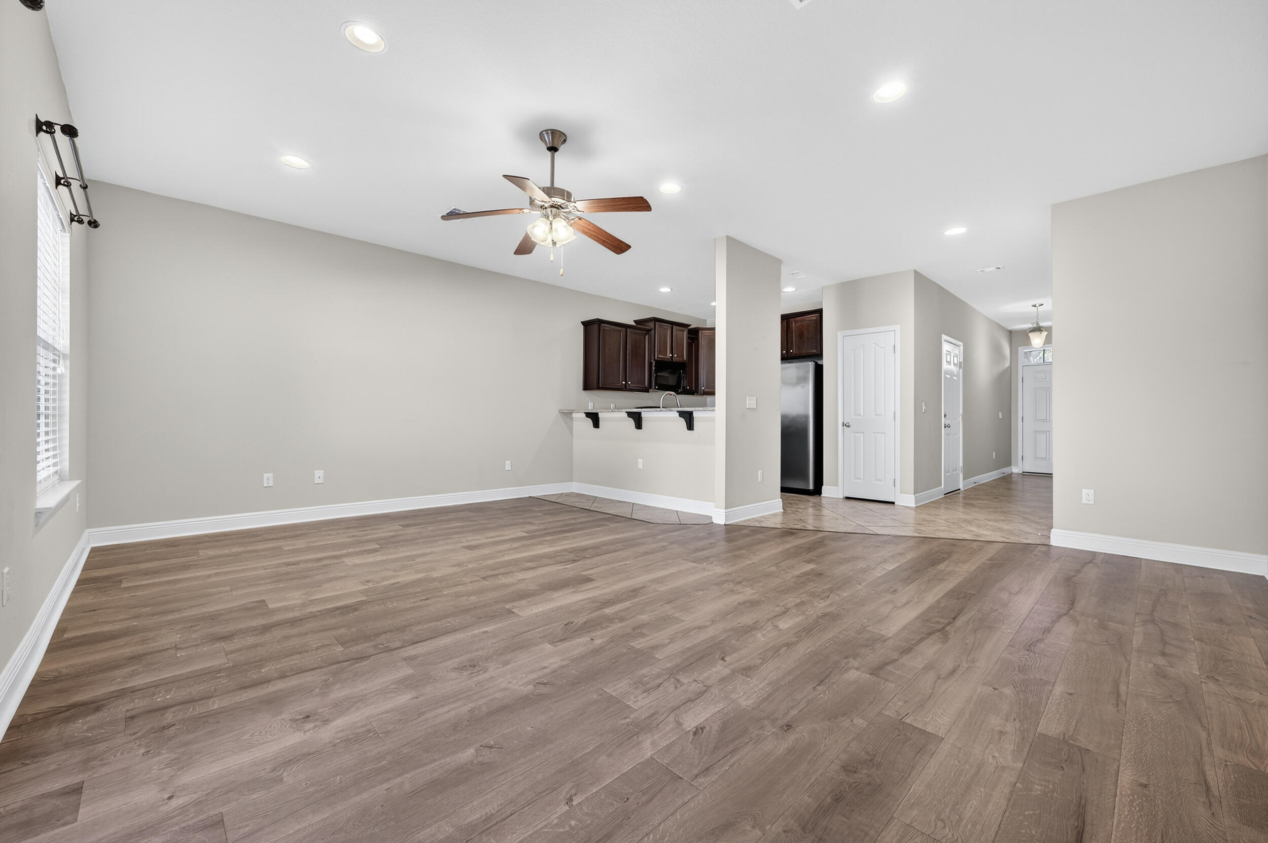 8900 White Ibis Way Navarre, FL 32566 - Photo 10 of 37 a view of empty room with wooden floor and ceiling fan