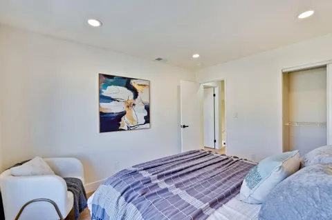 a view of a workspace with furniture and wooden floor