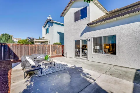 a picture of a room with a white wall and a refrigerator