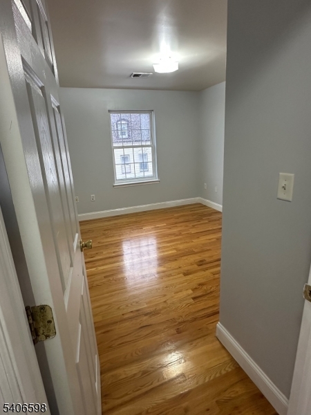 448 Catherine Street Elizabeth, NJ 07201 - Photo 6 of 11 a view of empty room with wooden floor