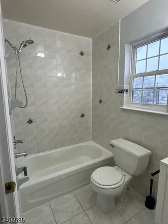 a bathroom with a toilet and a bath tub