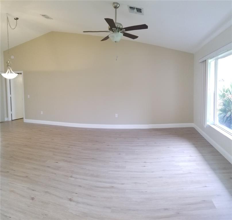 5810 Garden Lakes Majestic Bradenton, FL 34203 - Photo 13 of 28 a view of a room with wooden floor and a ceiling fan