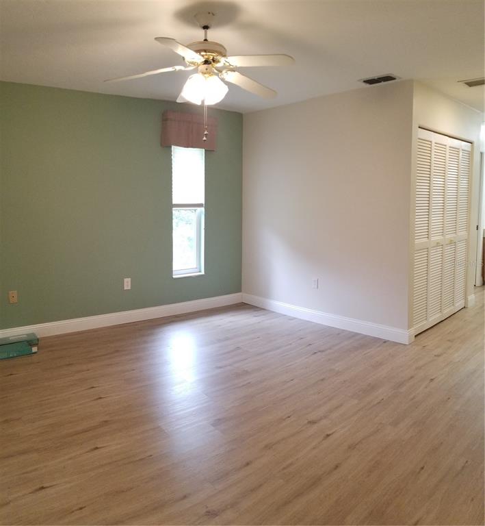 5810 Garden Lakes Majestic Bradenton, FL 34203 - Photo 16 of 28 an empty room with wooden floor and windows