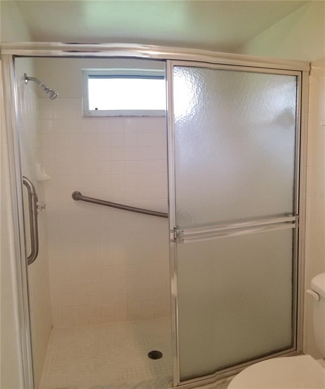 5810 Garden Lakes Majestic Bradenton, FL 34203 - Photo 20 of 28 a bathroom with a glass shower door
