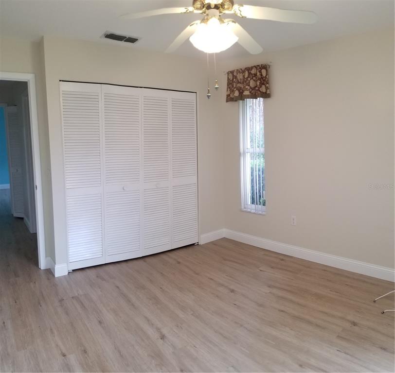 5810 Garden Lakes Majestic Bradenton, FL 34203 - Photo 22 of 28 a view of empty room with window and wooden floor