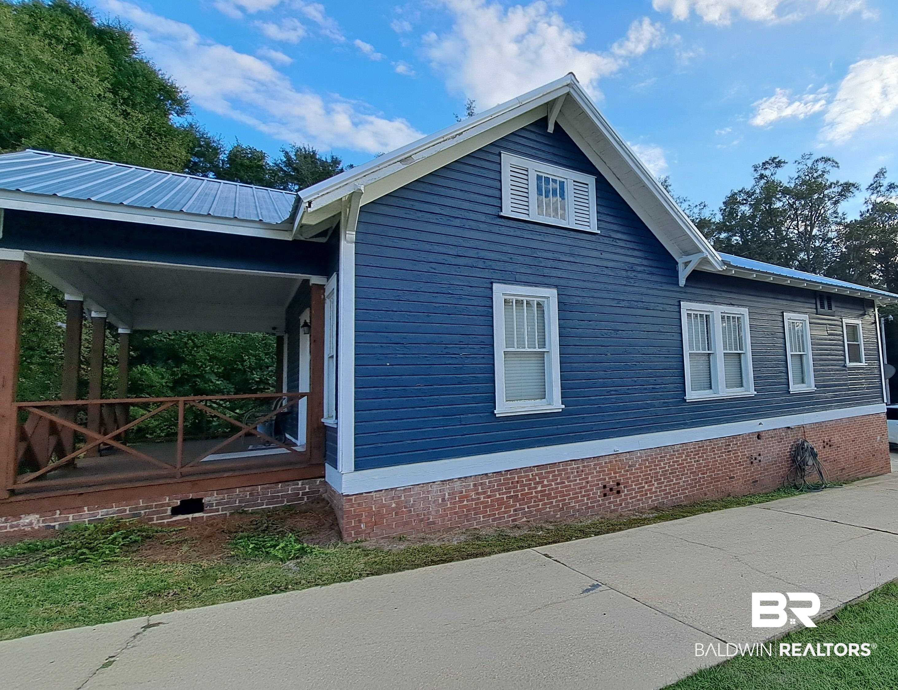 110 South Main Street Evergreen, AL 36401 - Photo 3 of 27 Blue clapboard siding with white trim