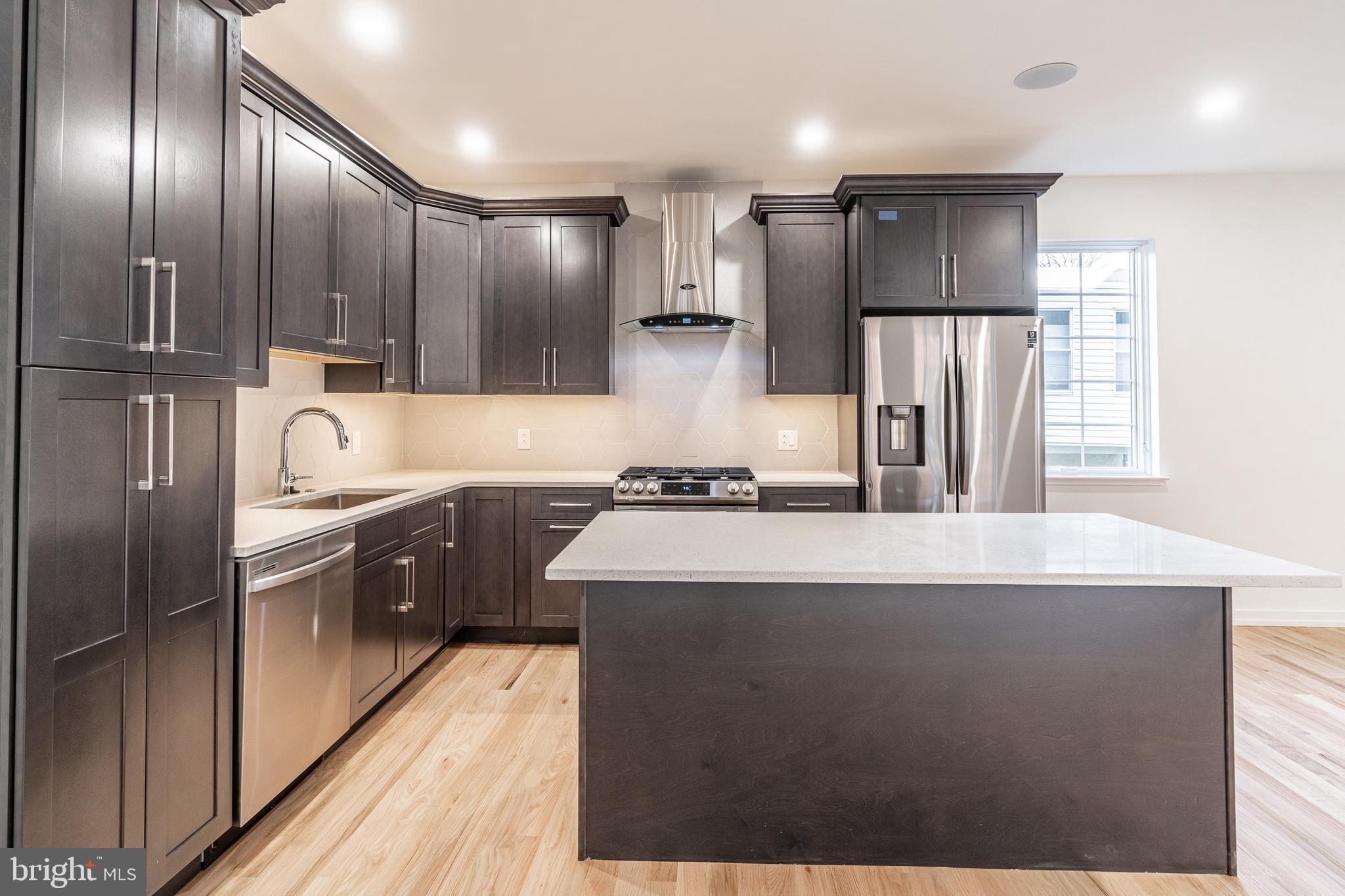 2423 Innovator Way Philadelphia, PA 19146 - Photo 11 of 34 a large kitchen with kitchen island granite countertop a refrigerator and a sink