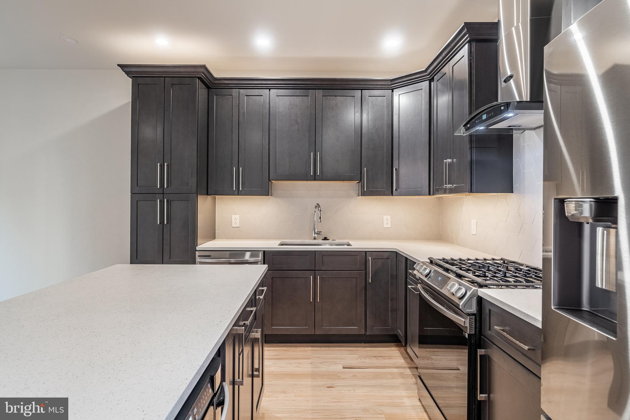 2423 Innovator Way Philadelphia, PA 19146 - Photo 12 of 34 a kitchen with kitchen island granite countertop a sink stainless steel appliances and cabinets