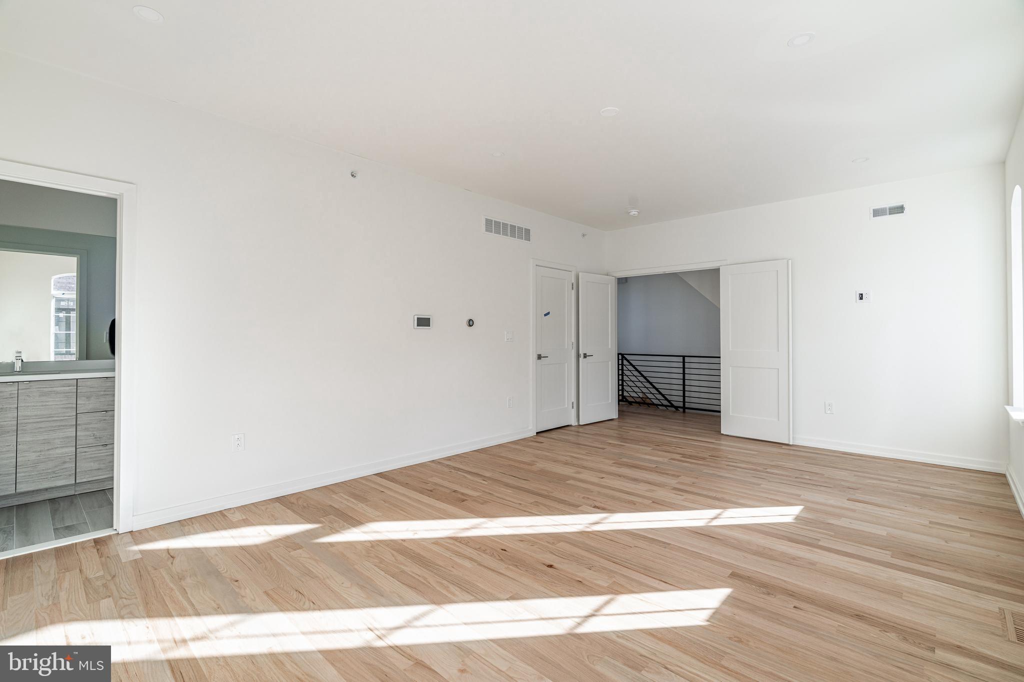 2423 Innovator Way Philadelphia, PA 19146 - Photo 18 of 34 a view of an empty room with wooden floor and a cabinet