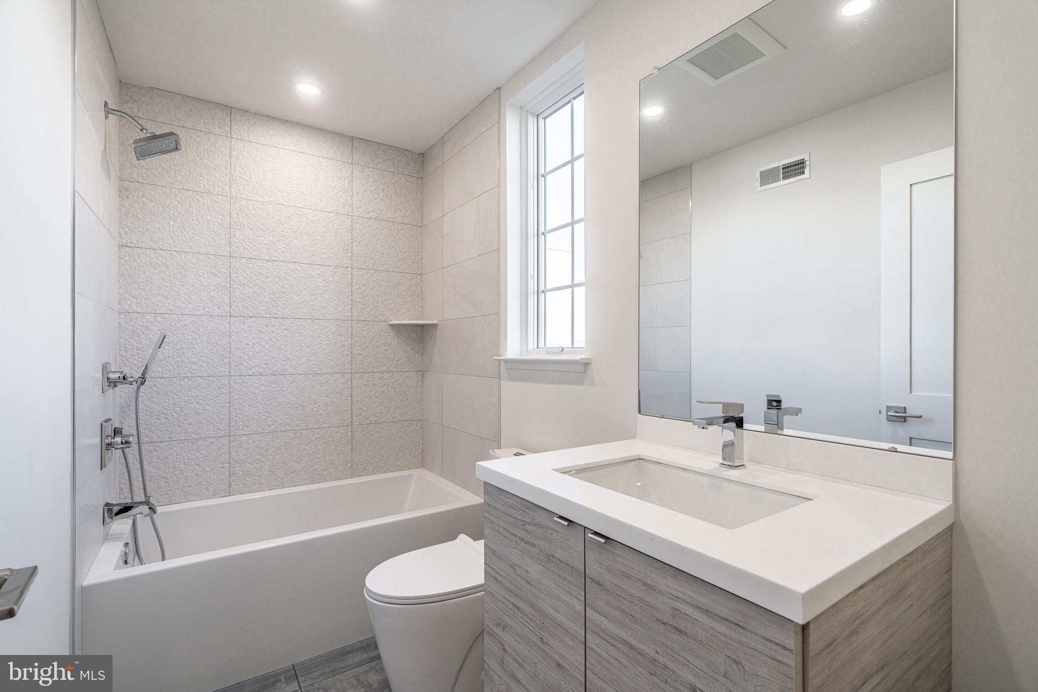 2423 Innovator Way Philadelphia, PA 19146 - Photo 27 of 34 a bathroom with a sink mirror toilet and bathtub