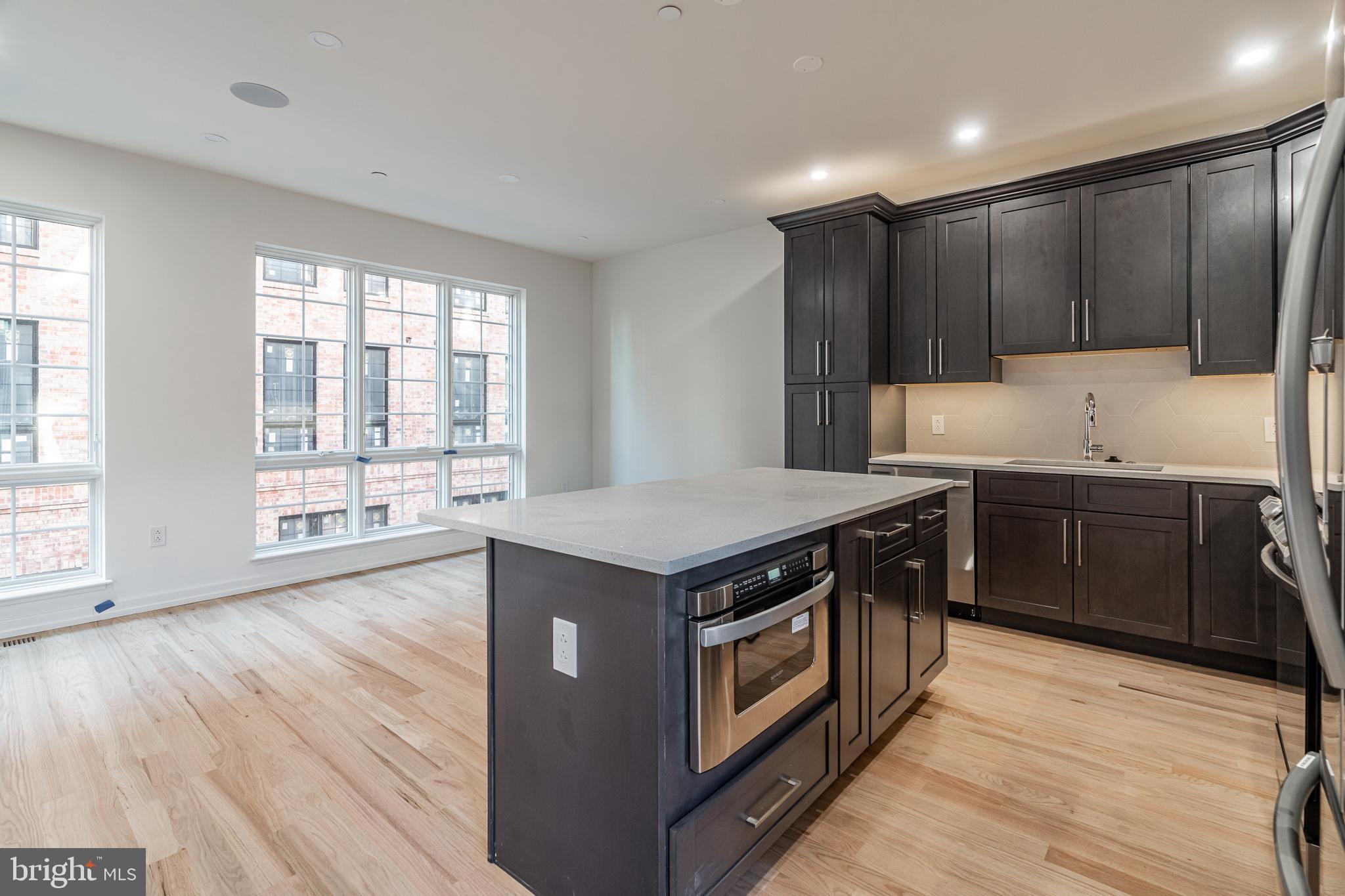 2423 Innovator Way Philadelphia, PA 19146 - Photo 9 of 34 a kitchen with a stove sink and cabinets