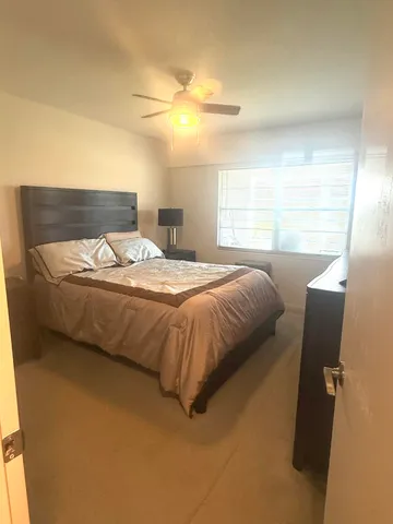 a bedroom with a bed and window