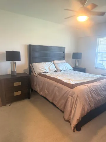 a bedroom with a bed and a lamp